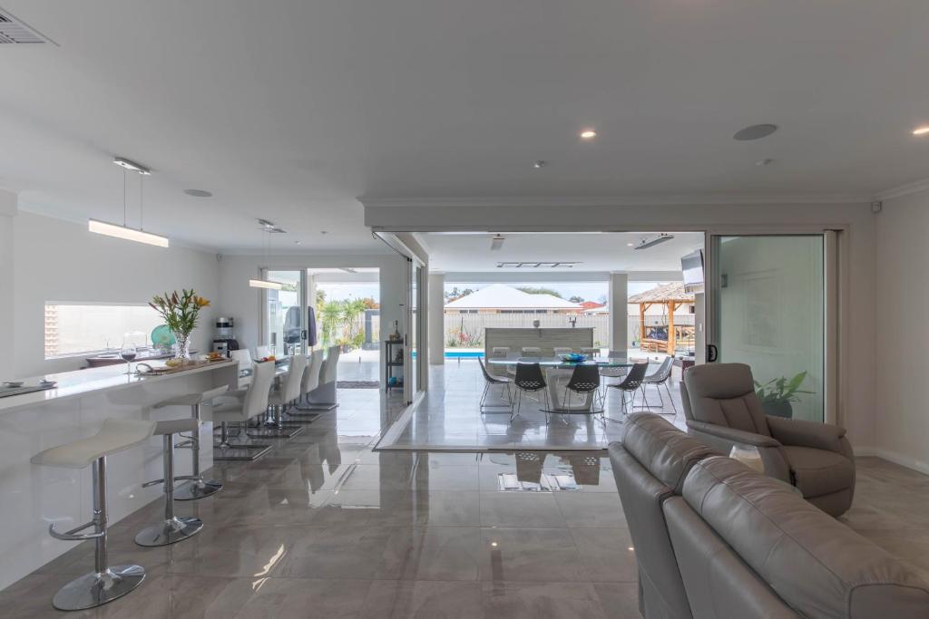 a living room with a long table and chairs at Epsom on Swan Bed & Breakfast in Perth