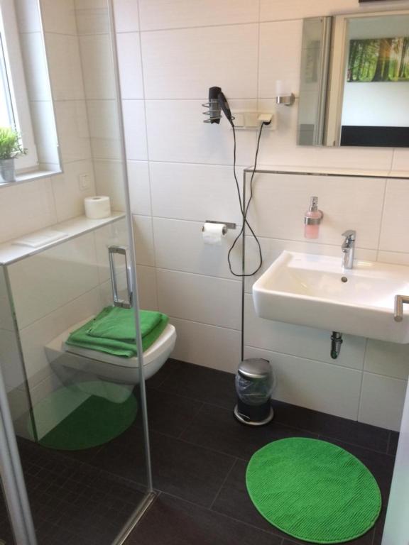 a bathroom with a toilet and a sink at Bergcafè - Hotel Kammann in Essen