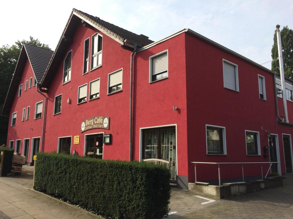 a red building with a red building at Bergcafè - Hotel Kammann in Essen