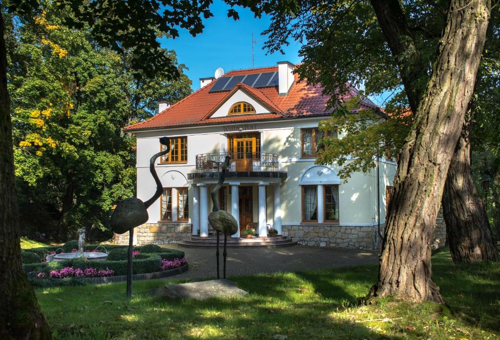 a white house with a red roof at Willa Raj in Nałęczów