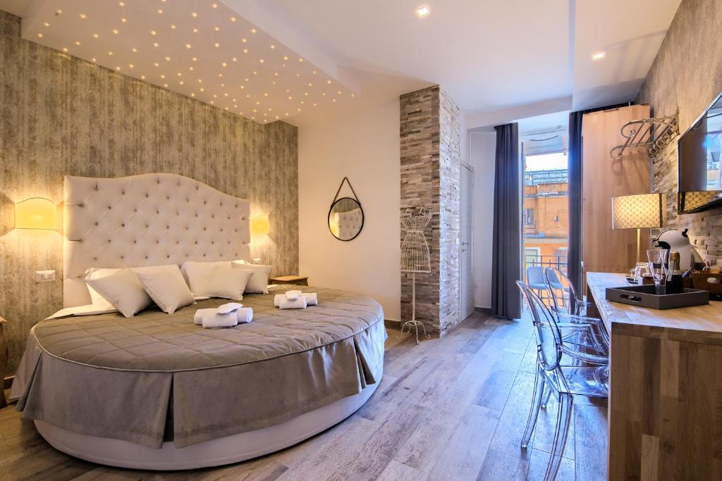 a bedroom with a large bed in a room at Veneto Suite Rome in Rome