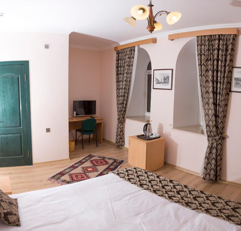 a bedroom with a bed with a green door at City Walls Hotel in Baku