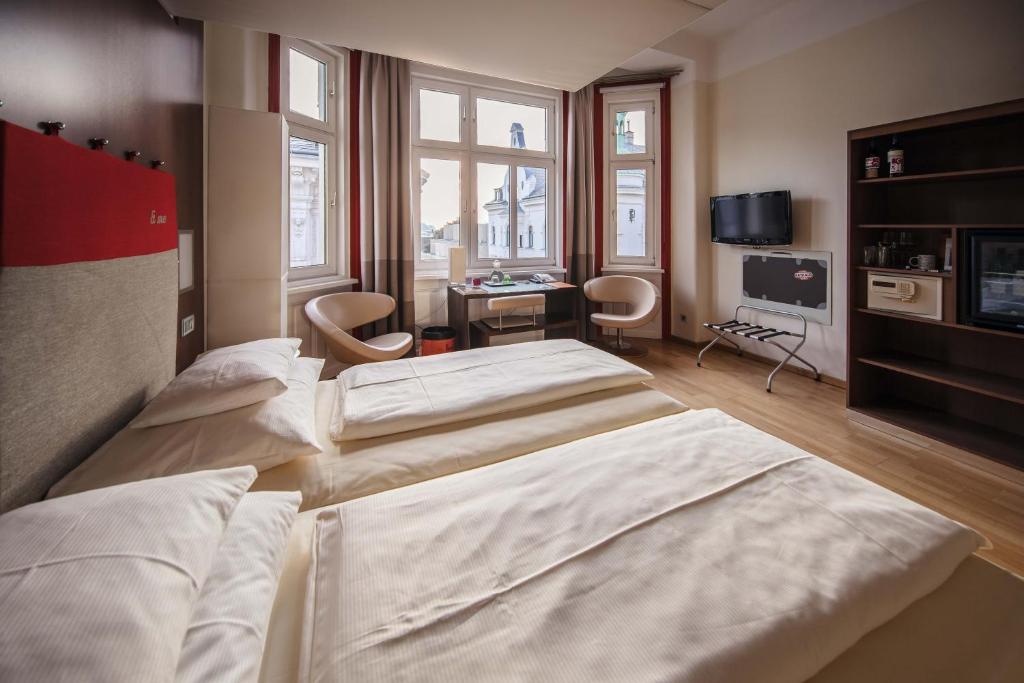 A bed or beds in a room at Hotel Rathaus - Wein & Design