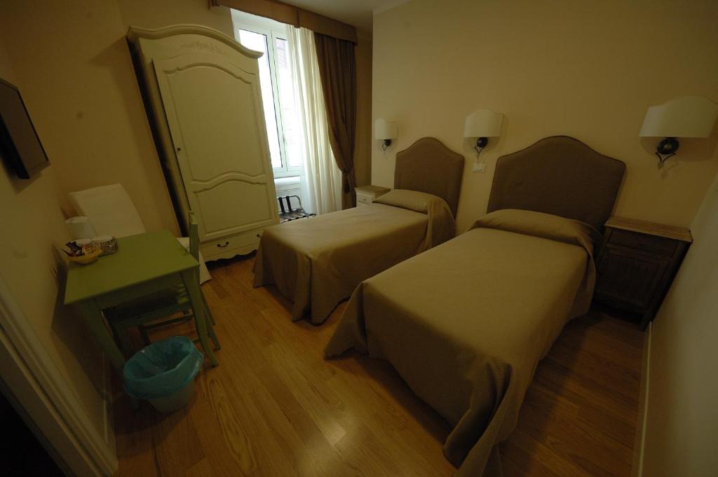 Łóżko lub łóżka w pokoju w obiekcie Residenza Dei Gracchi