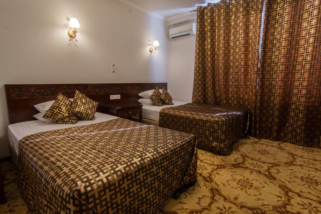 Postel nebo postele na pokoji v ubytování Klassik Hotel