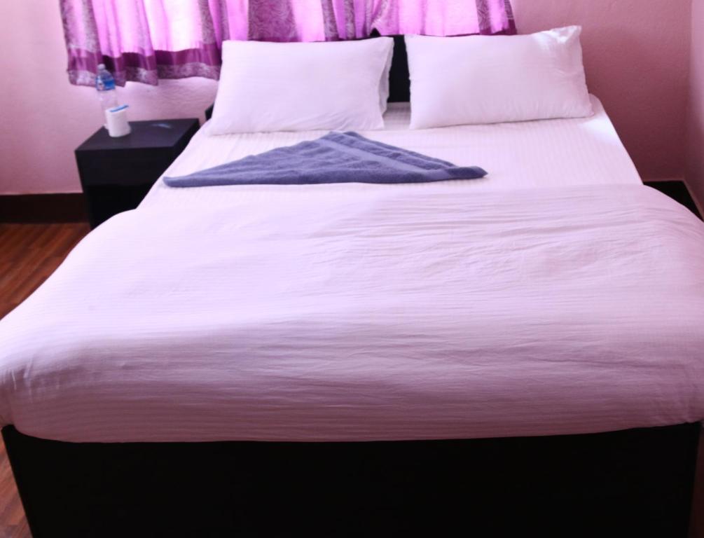 Postel nebo postele na pokoji v ubytování Mitra Garden Inn