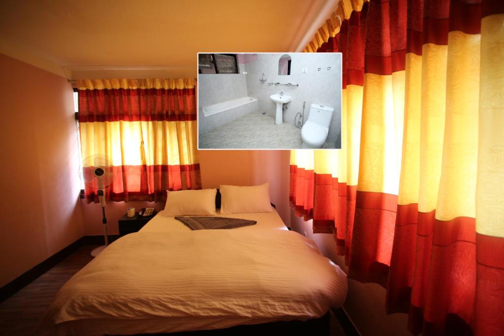 Postel nebo postele na pokoji v ubytování Mitra Garden Inn