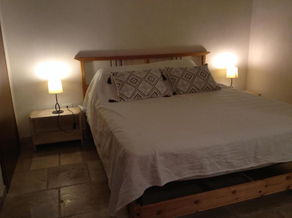 Postel nebo postele na pokoji v ubytování Trulli e Masseria Ianella