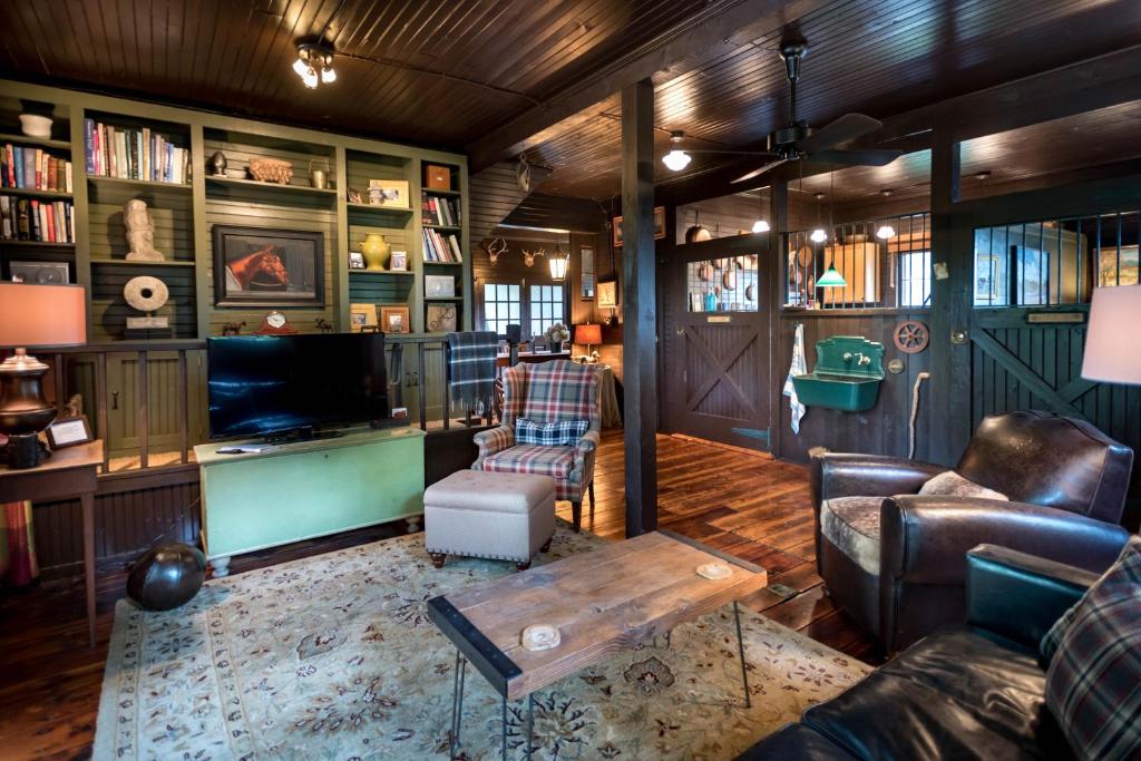 a living room with a couch and a table at The Stables in Kingston