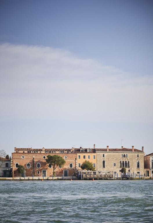 a large brick building next to a body of water at Hotel Cipriani, A Belmond Hotel, Venice in Venice
