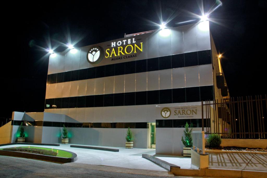 a hotel with a sign on the side of a building at Hotel Saron in Luziânia