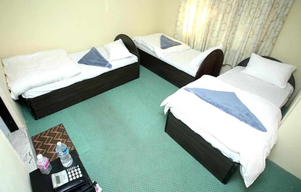 Postel nebo postele na pokoji v ubytování Mitra Garden Inn