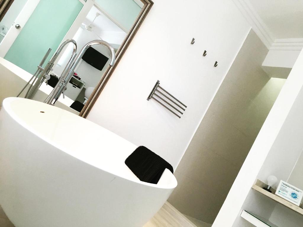 a bathroom with a white sink and a mirror at Casa Veintiuno in Sosúa