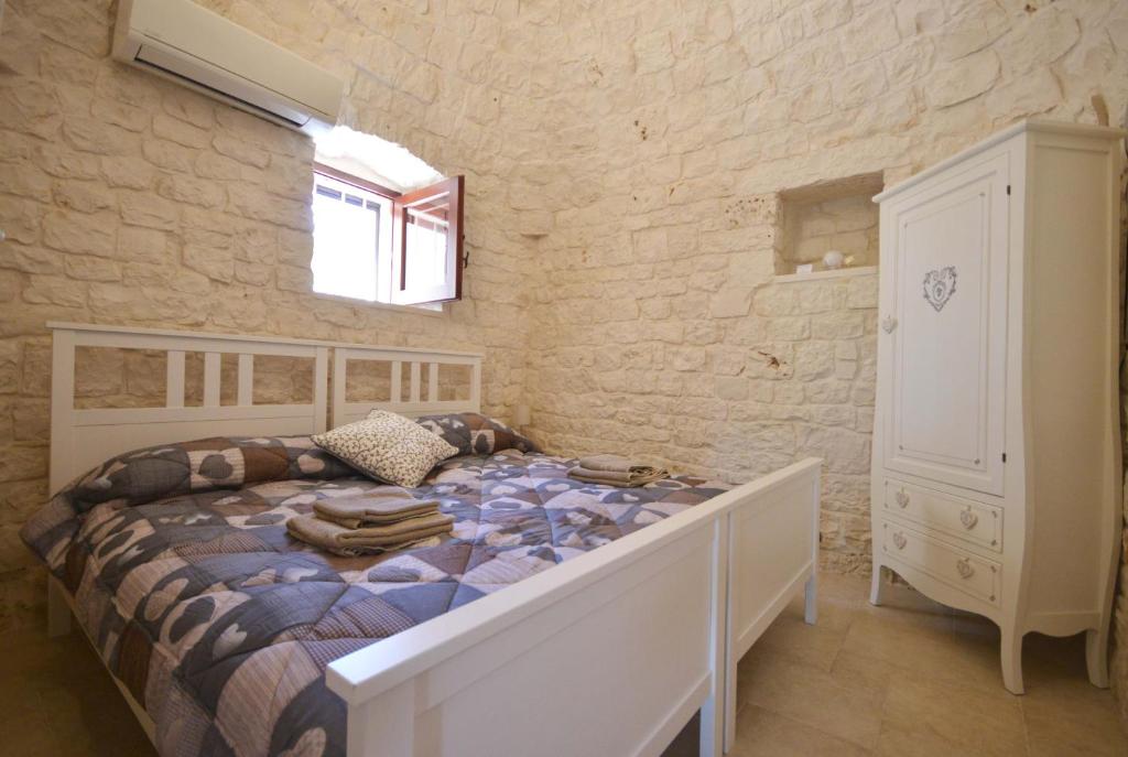 Postel nebo postele na pokoji v ubytování Trulli Petra Chiara