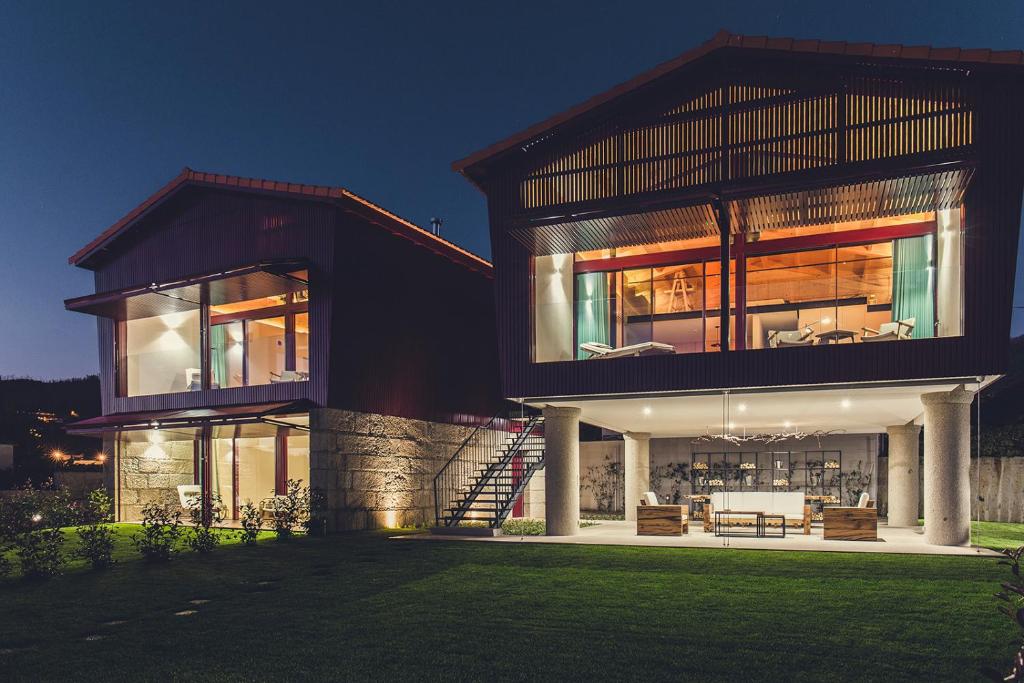 a large house with a lot of windows at Quintãs Farm Houses in Arouca