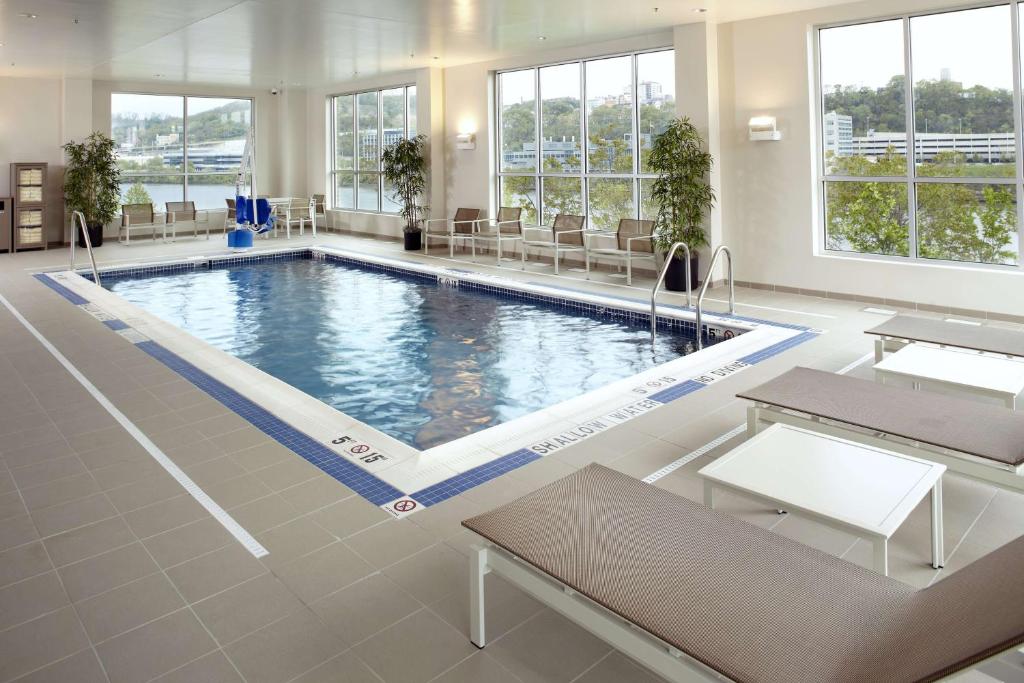 a large swimming pool in a large room with windows at Hyatt House Pittsburgh-South Side in Pittsburgh