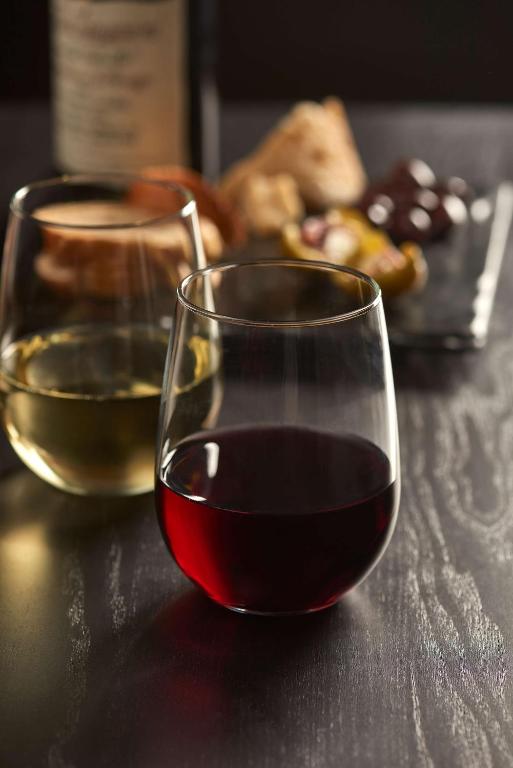 two glasses of wine sitting on a table at Hyatt House Naples 5th Avenue in Naples