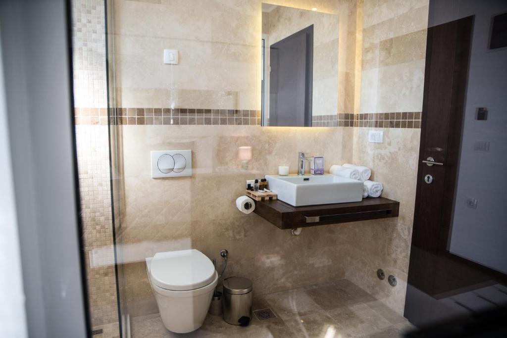 a bathroom with a toilet and a sink at Boutique Hotel "Salina" in Ulcinj