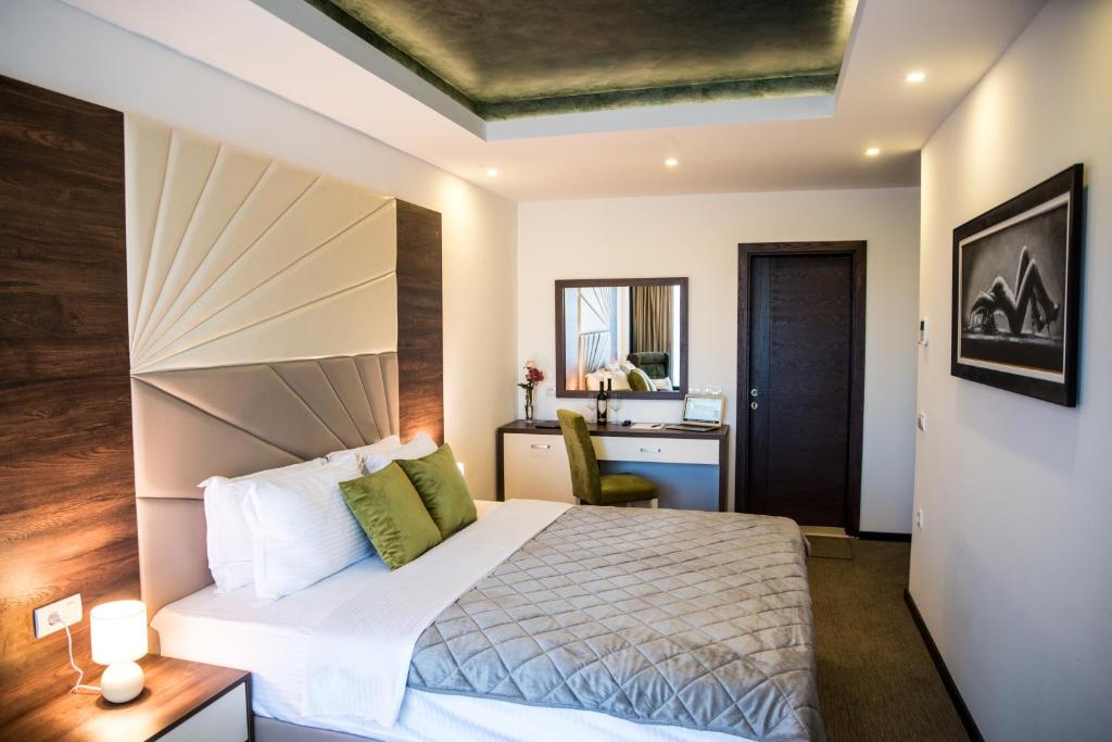a hotel room with a bed and a desk at Boutique Hotel "Salina" in Ulcinj