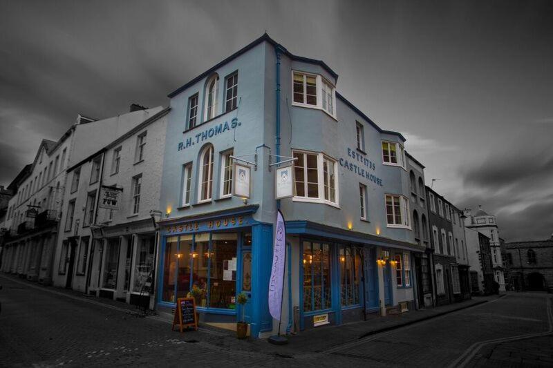 a blue and white building on a city street at Ty Castell in Caernarfon