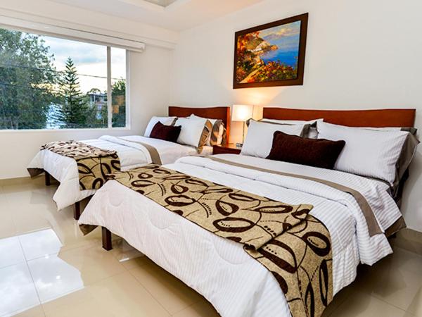 Postel nebo postele na pokoji v ubytování Hotel Fontanar Usaquen