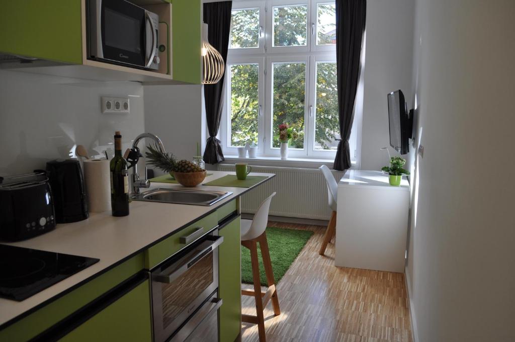 a kitchen with a sink and a counter top at Studio Apartments City&style in Zagreb