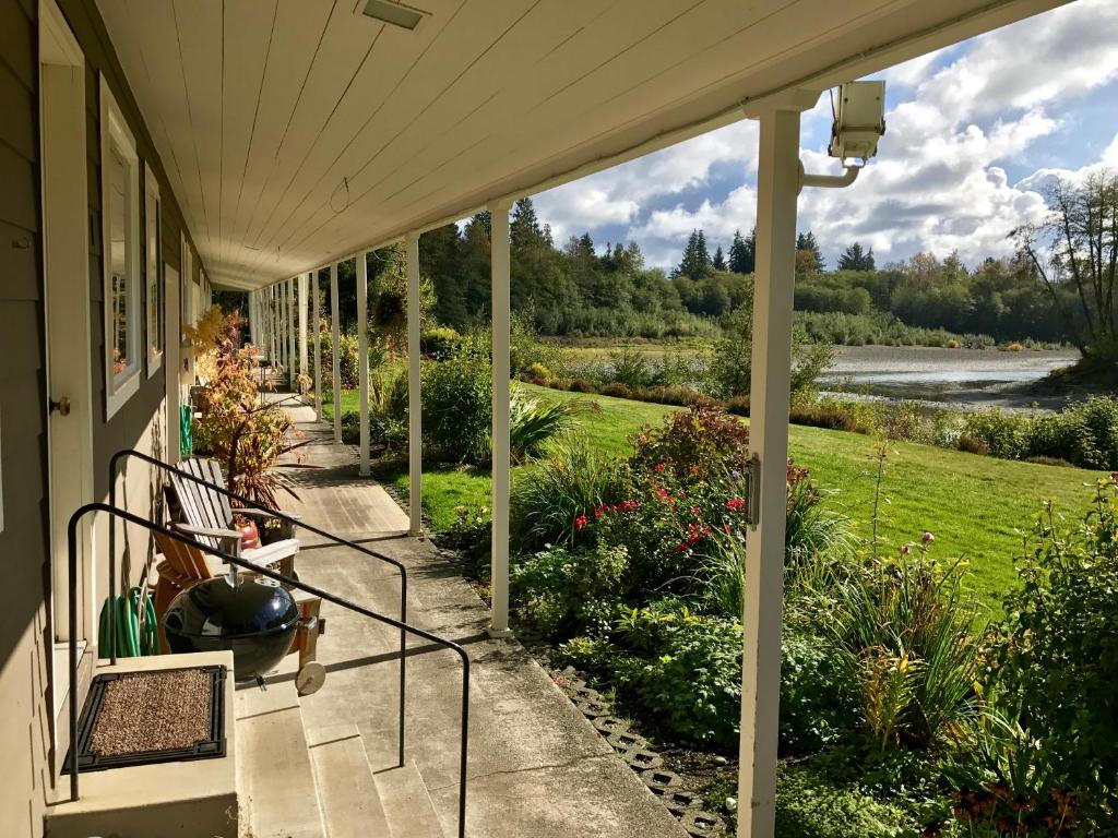 a porch of a house with a view of a garden at Quillayute River Resort in Forks