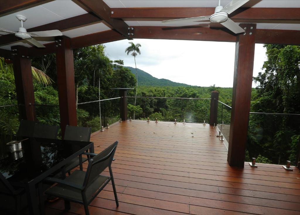 a wooden deck with a view of a mountain at Stonewood Views in Diwan
