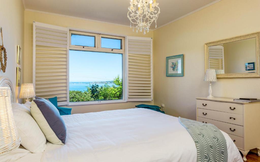 a bedroom with a bed and a large window at Victor Apartments in Victor Harbor