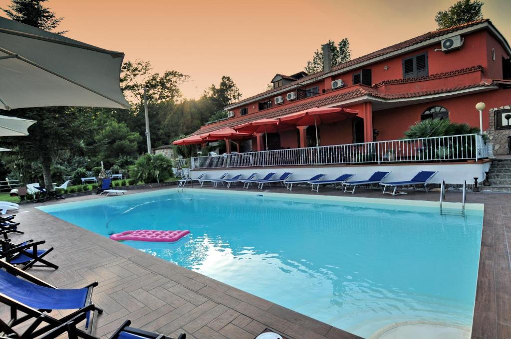 a large swimming pool in front of a hotel at Villa Fernanda in Cava deʼ Tirreni