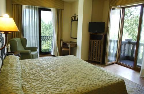 Postel nebo postele na pokoji v ubytování Hotel Abeiras