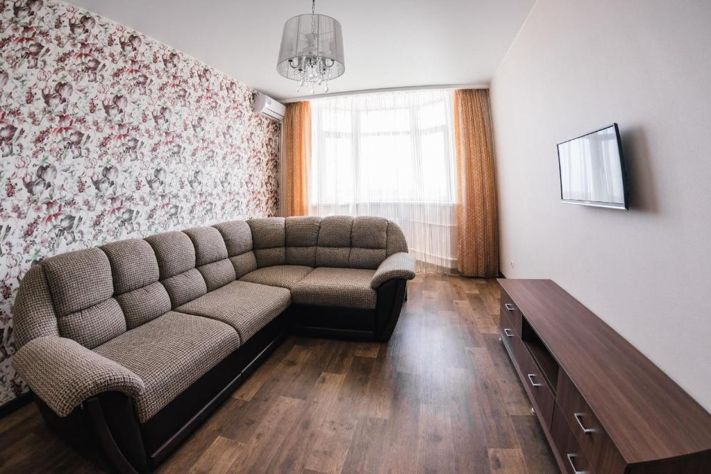 a living room with a couch and a window at Apartment on Mira 3/1 in Orenburg