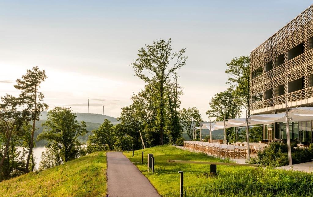 a building with a path next to a building at Seezeitlodge Hotel & Spa in Gonnesweiler