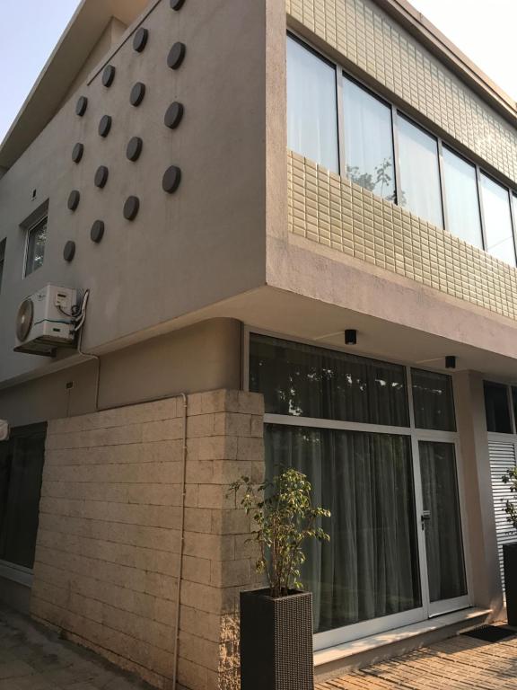 um edifício com uma planta de vasos em frente em Casas de Luanda-GH Kinaxixe em Luanda