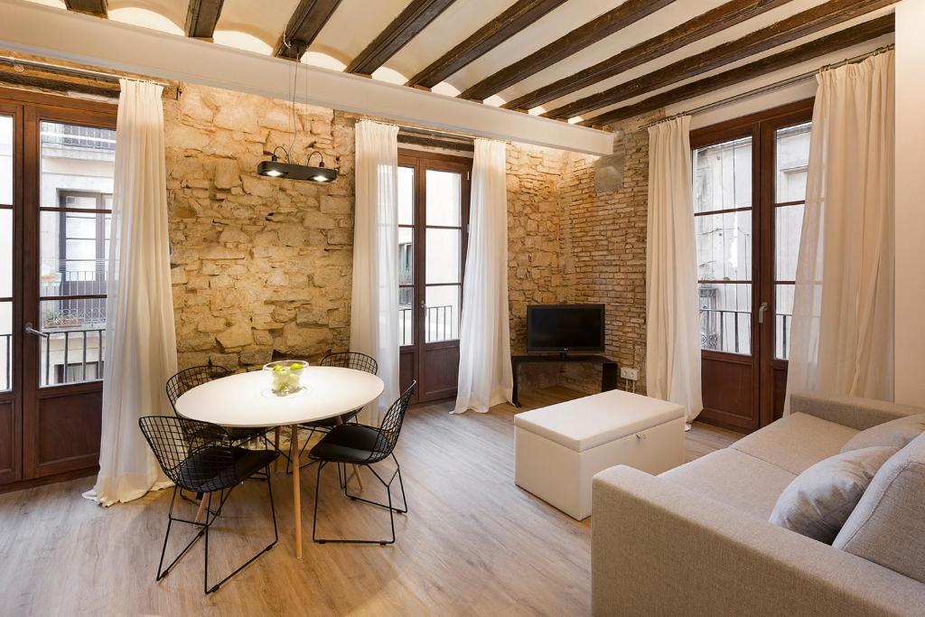 a living room with a table and a couch at Decô Apartments Barcelona-Born Apt. in Barcelona