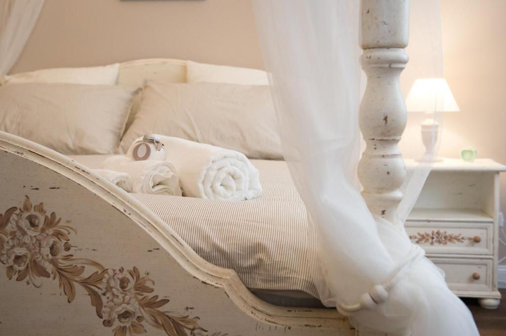 - une chambre avec un lit blanc à baldaquin dans l'établissement Magnolia St.Peter's Suites, à Rome