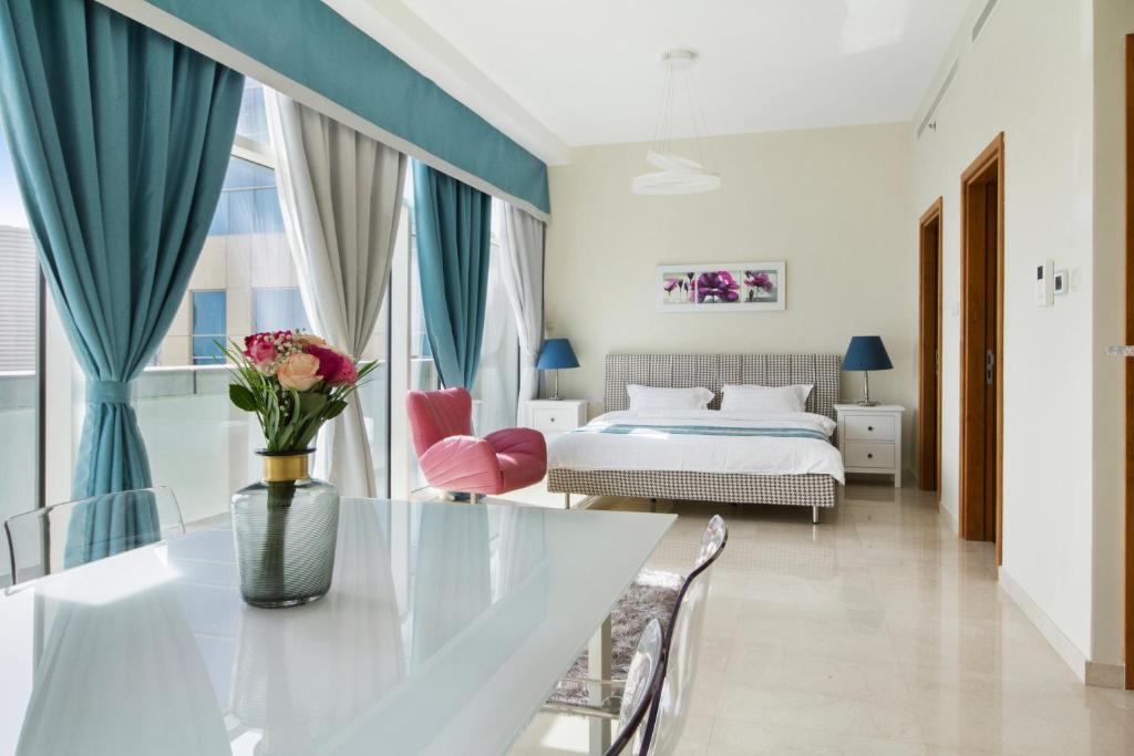 a hotel room with a large bed and a large window at Bespoke Holiday Homes - Bay Square in Dubai