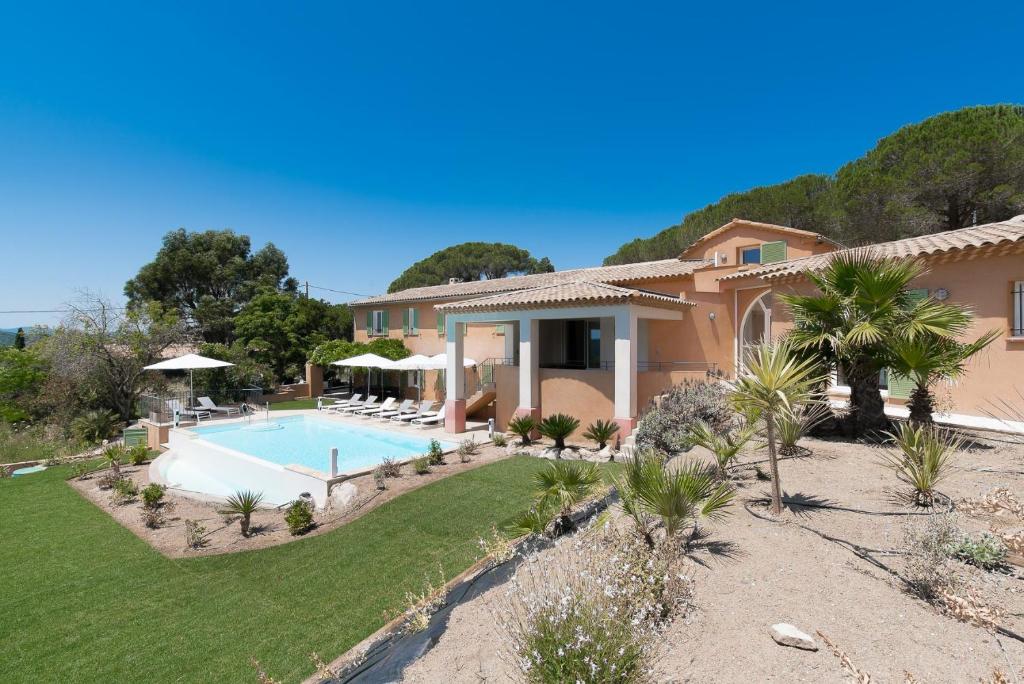 a villa with a swimming pool and a resort at Villa LAURIERS ROSES Saint Tropez in Saint-Tropez