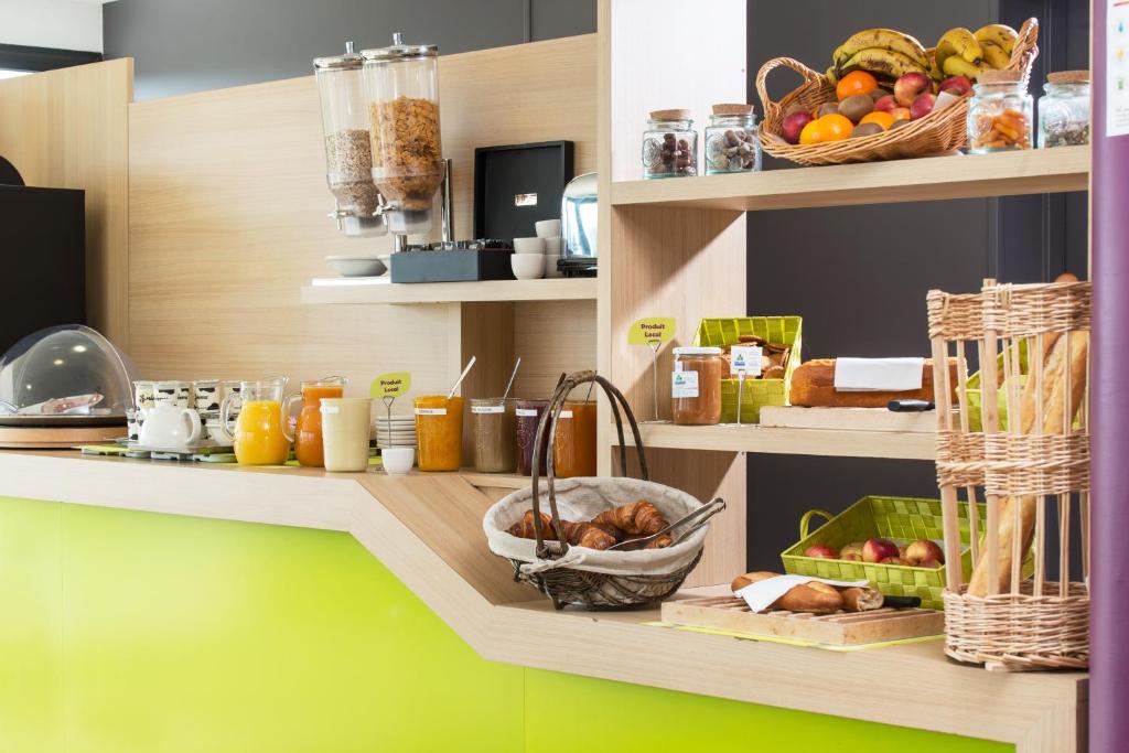 a shelf with fruits and other items on it at Eco Nuit La Baule Guerande in Guérande