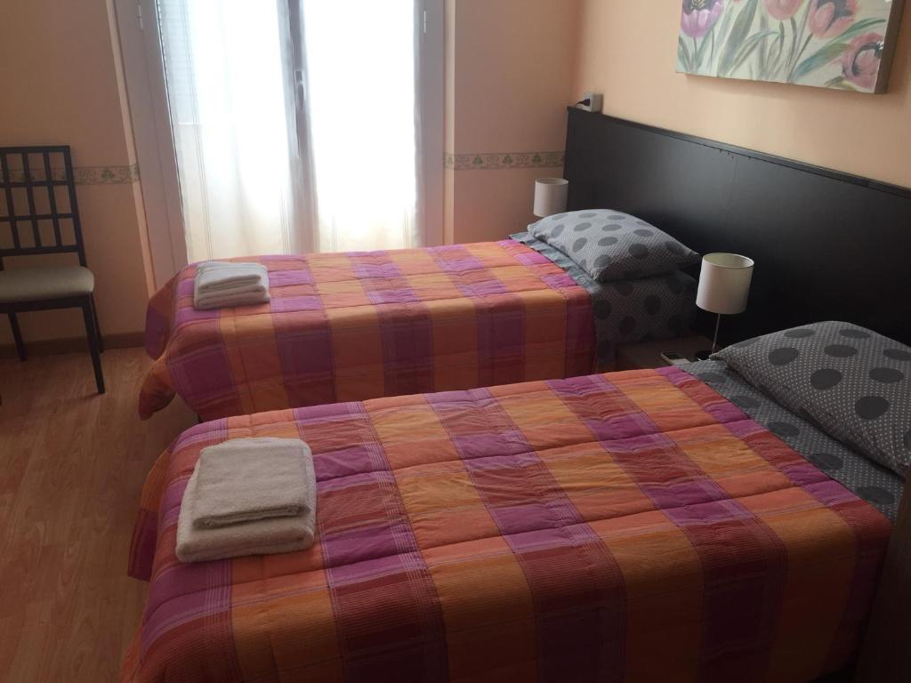 Łóżko lub łóżka w pokoju w obiekcie Locanda Beatrice