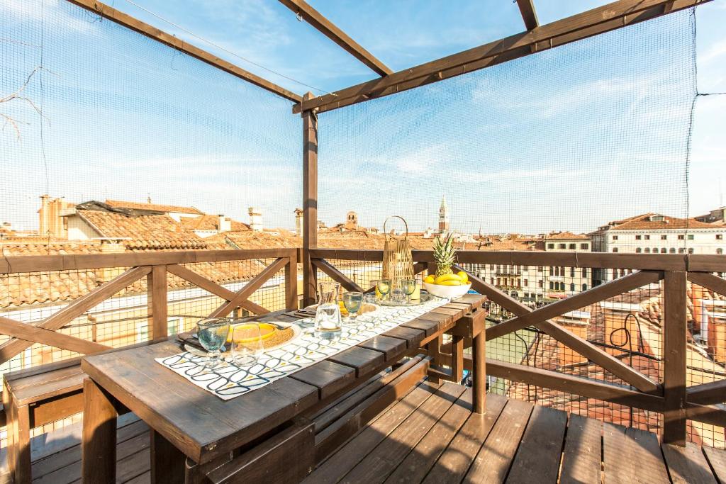 a table on a balcony with a view of the city at Grand Canal Design Apartment in Venice