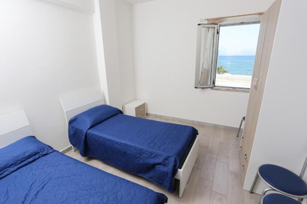 Postel nebo postele na pokoji v ubytování Camping Lido di Salerno