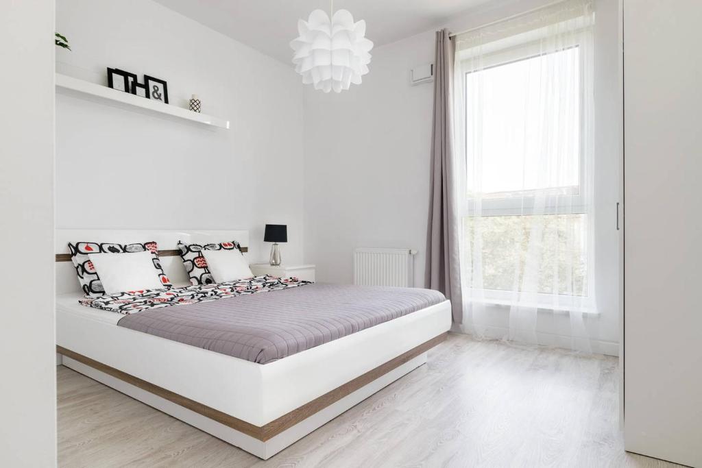 Ένα ή περισσότερα κρεβάτια σε δωμάτιο στο Good Time Apartments Kościelna 17 19