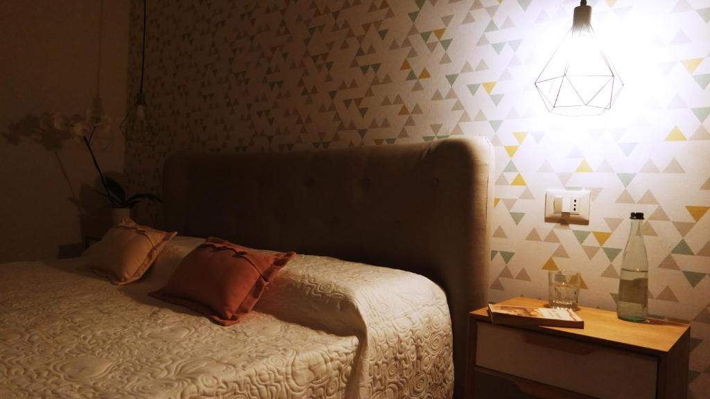 Postel nebo postele na pokoji v ubytování IndispArte Suites