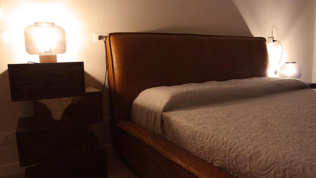 Postel nebo postele na pokoji v ubytování IndispArte Suites