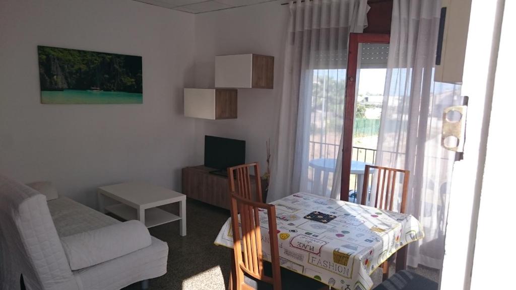 a small living room with a table and a couch at Apartamentos Juan Jose in Lloret de Mar