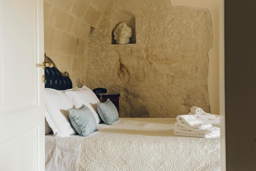 a bedroom with a bed with towels on it at Casastella in Matera