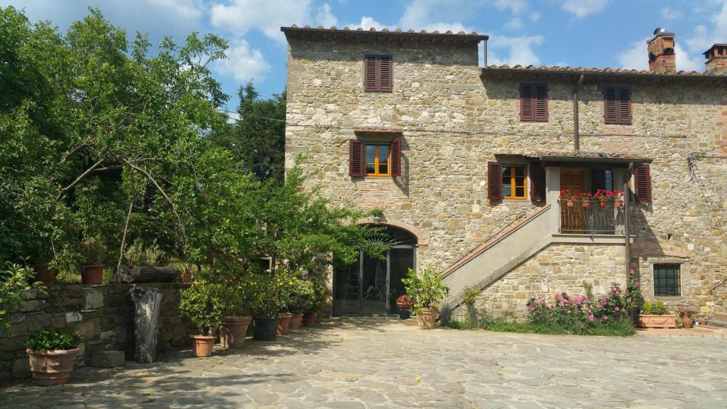 ein altes Steinhaus mit einer Treppe davor in der Unterkunft Colonica Montebeni in Greve in Chianti