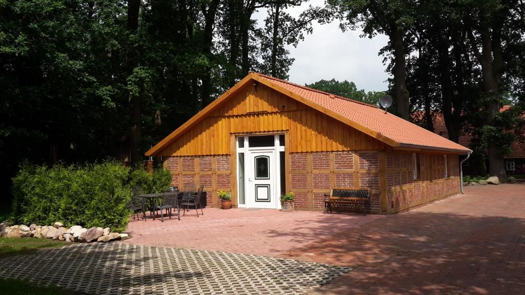 a small brick building with a white door at Ferienhaus Poppe in Löningen