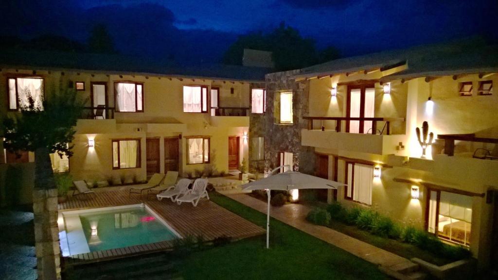 a house with a swimming pool at night at Al Sereno Hotel Panoramico in Tilcara